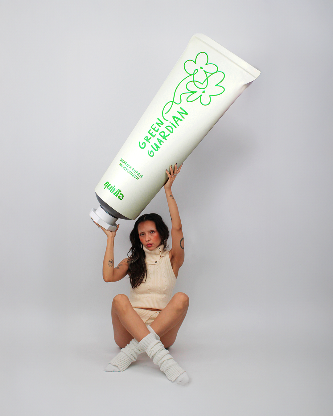 QUINTA's Green Guardian Barrier Repair Moisturizer — oversized product campaign shot with a playful, surreal twist. Petroleum-free, small-batch natural moisturizer for dry and sensitive skin, hand-formulated in Berlin.