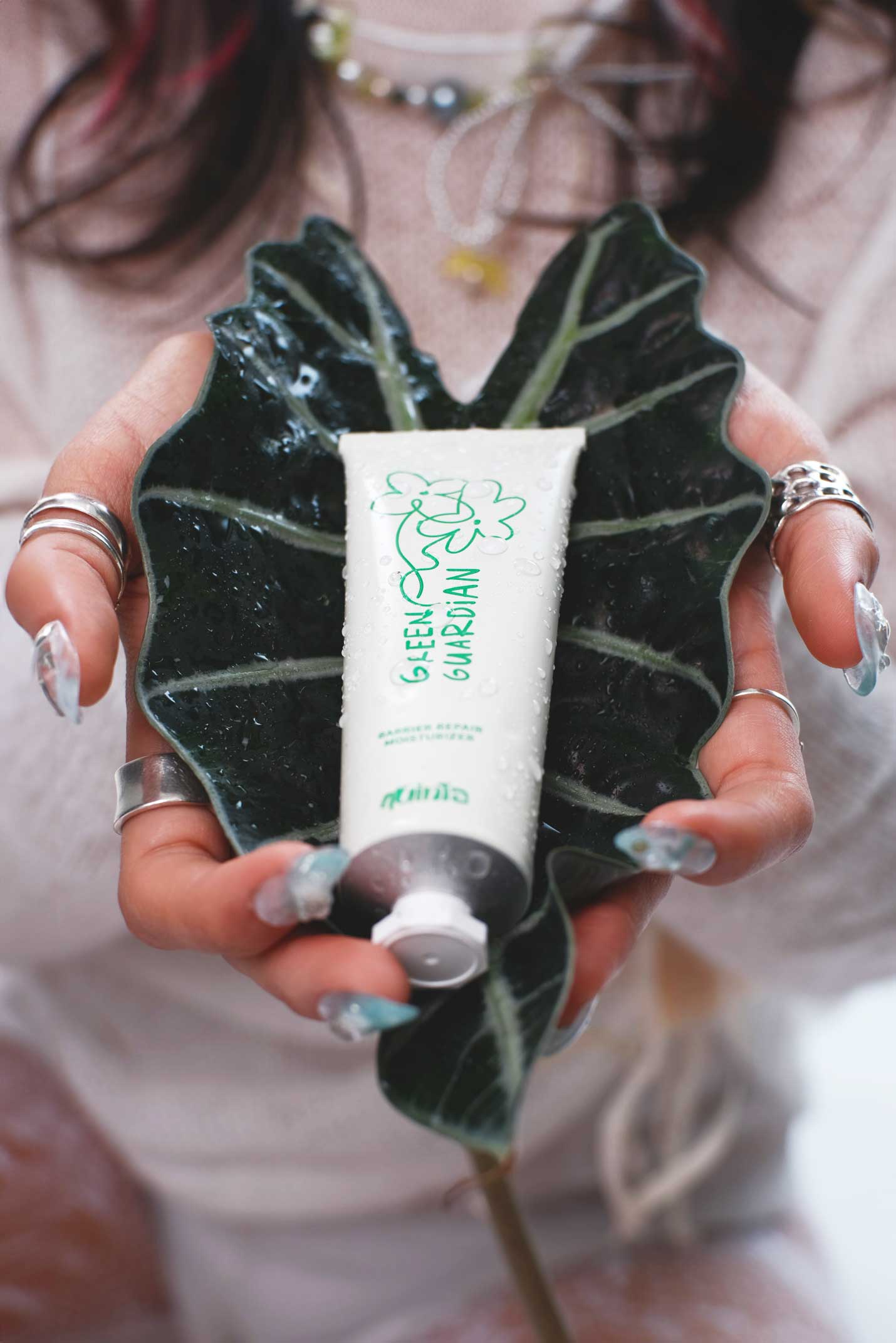 Hands holding Green Guardian Barrier Repair Moisturiser Cream