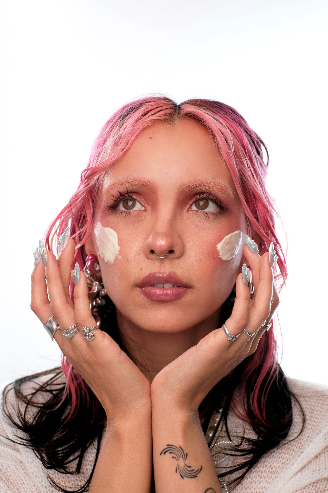 Face closeup of model with a swatch of the barrier repair cream in each sides of their face