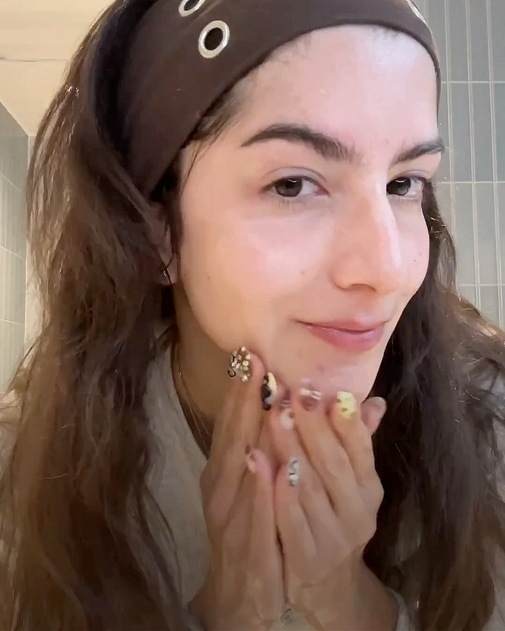 Woman washing her face in a bathroom setting